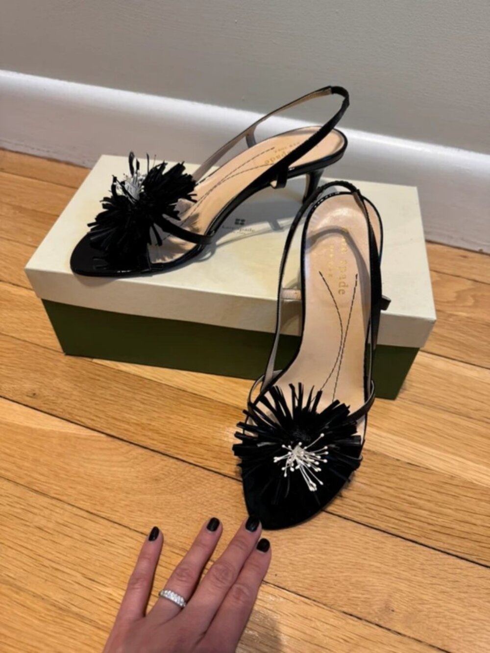 Kate Spade Black Patent Leather Slingbacks with flower detail.